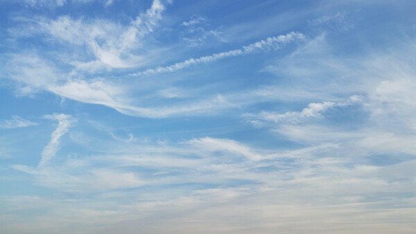 photo of some stripey clouds in a blue sky.
