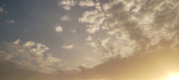 Sunset sky, with sunlight peeking through the bottom right corner