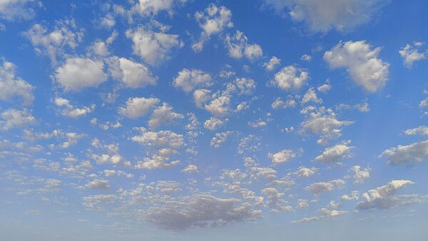 A photo of a blue sky with randomly scattered clouds of different sizes, from some medium sized ones to small fluffballs