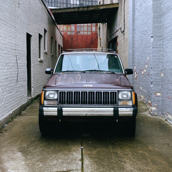 A jeep in an alleyway