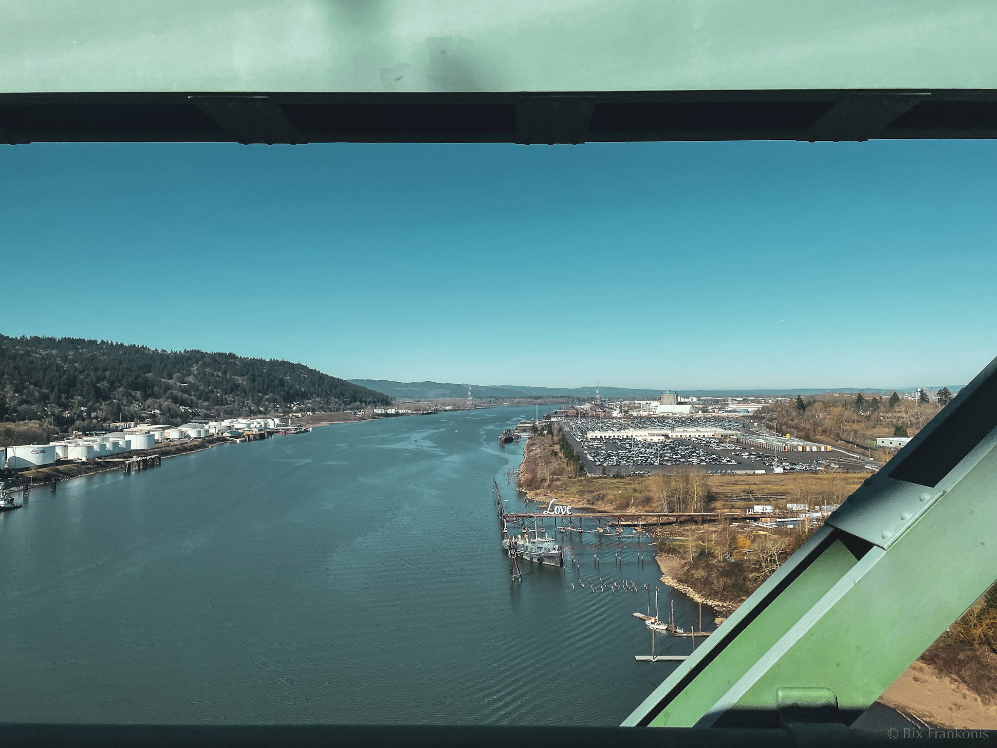 Looking northwest from a green bridge where you can jus tbarely make out a tiny dock with a white, cursive sign reading Love.