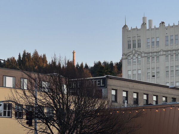 The Astoria Column shines in the background as sun goes down. Taken from the Astoria Riverwalk.