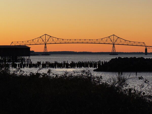 Astoria-Megler Bridge with an orange sky background.