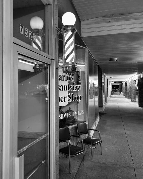 A black and white photograph of a barber pole