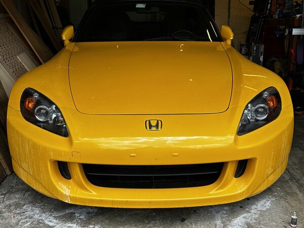 Just finished clearing the head lamps up. Still needs a wash after it cures.

Description: Yellow Honda S2000 parked after minor detailing work on the head lamps.