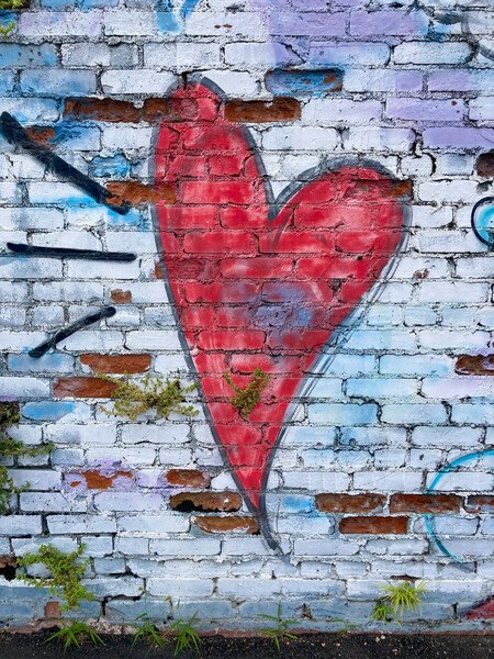 Snap #21: Graffiti heart on a crumbling brick wall.