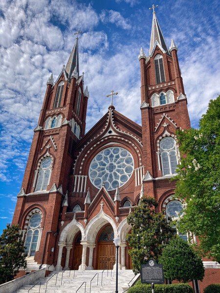 St Joseph Catholic Church in downtown Macon, Georgia. The twin spires rise 200 feet. The interior features 60 stained glass windows, a white Carrara marble altar and pulpit, and an organ with 1,000 pipes.