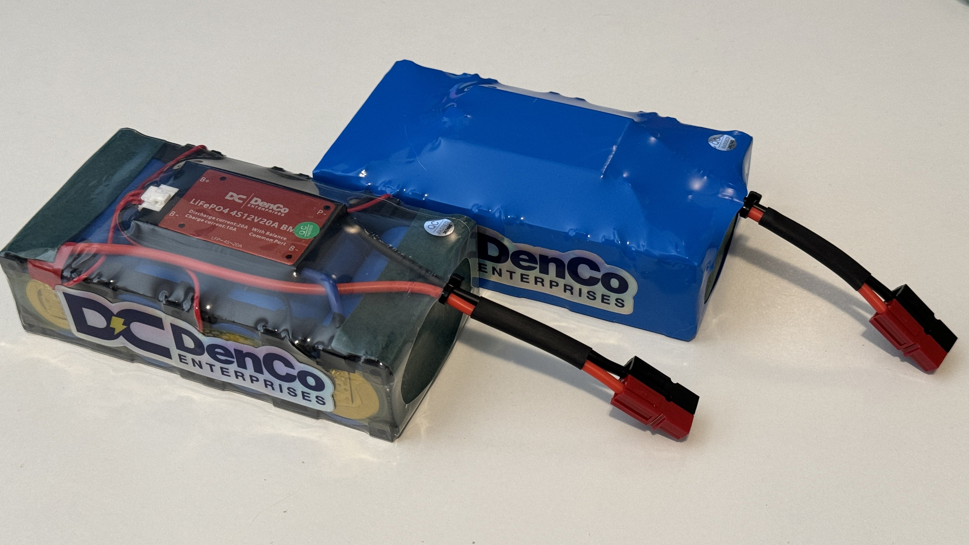A clear-wrapped DenCo battery build dubbed 'Demonstrator Edition' alongside a standard blue-wrapped battery 5.5Ah battery build