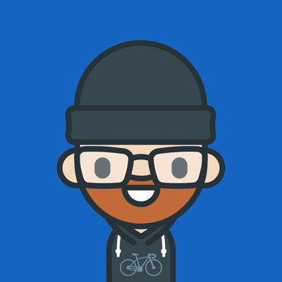 Profile picture in the unmistakable style of Andy Carolan. Me with a cap, glasses and a hoodie with a racing bike on it.