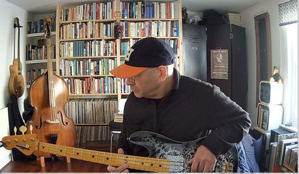 Ezri playing his bass guitar