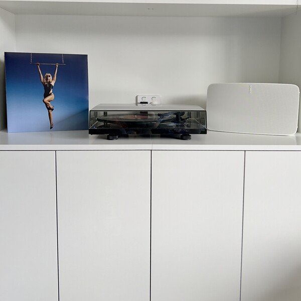 A record player and a Sonos Five speaker playing the album Endless Summer Vacation by Miley Cyrus