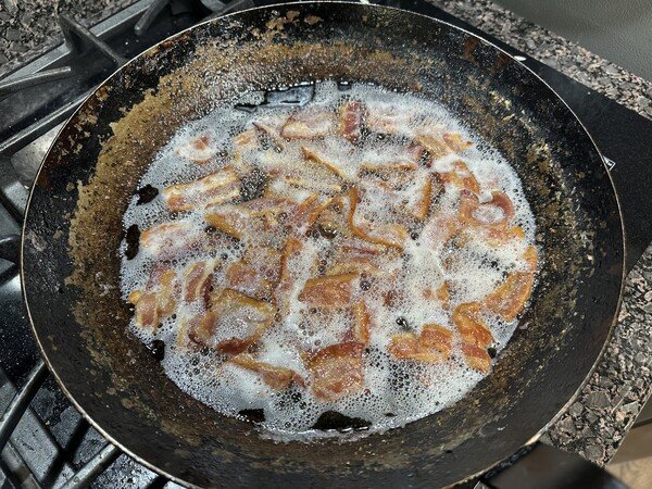 Sautéing Bacon.

It's the simmer and sauté method, worked really well!