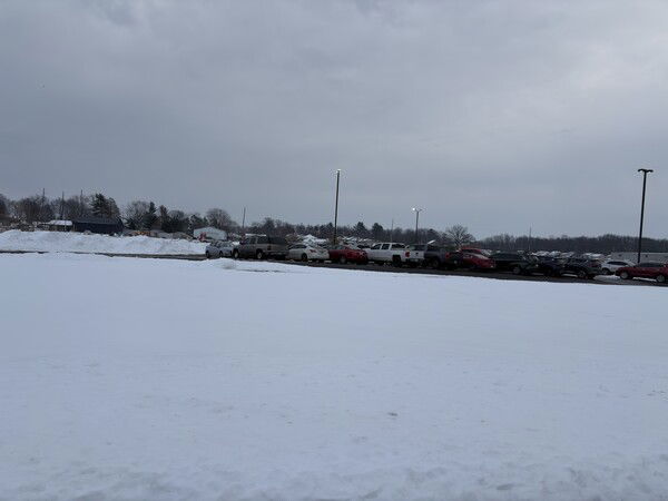 Back to the real world/office.

Snow-covered parking lot with parked cars under a gray cloudy sky.