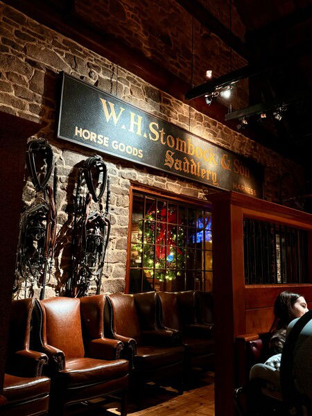 Decorative wall in Clyde’s Restaurant main dining room, with Christmas wreath in window. 

#Photography 