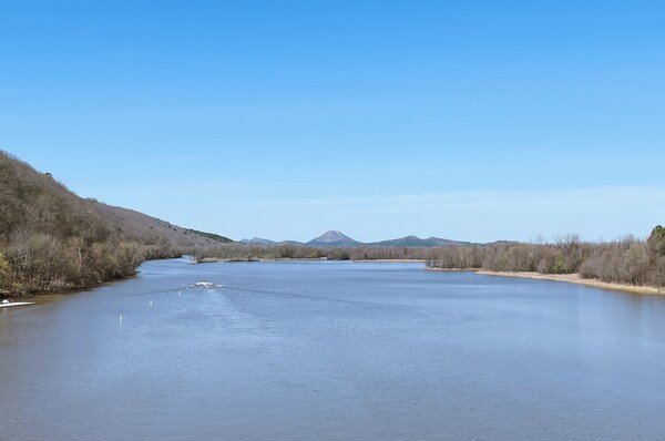 Pinnacle Mountain on the horizon at the head of a river