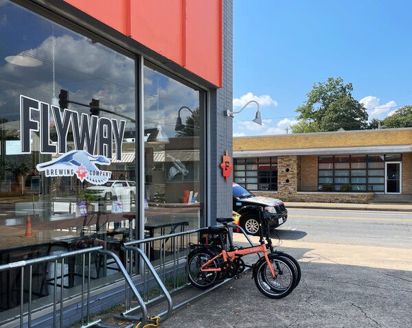 A couple bikes parked in front of Flyway Brewery, North Little Rock, and a bit of the 70s streetscape beyond. 