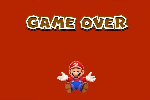 A red screen from a Mario video game. The words 'GAME OVER' are at the top of the screen, and at the bottom of the screen, Mario is sitting down, shrugging, with a sleepy expression on his face.