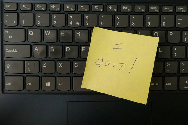 A yellow sticky note is placed on the black keyboard of a laptop. The sticky note has the words 'I QUIT!' handwritten on it in dark marker. The image is a close-up, high-contrast flat lay, conveying a mood of sudden departure or resignation in a professional context.  [Photo by Nick Fewings](https://unsplash.com/@jannerboy62?utm_source=unsplash&utm_medium=referral&utm_content=creditCopyText)  on [Unsplash](https://unsplash.com/photos/a-yellow-notepad-on-a-keyboard-GpplHQ-fyvA?utm_source=unsplash&utm_medium=referral&utm_content=creditCopyText). 