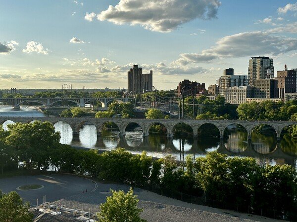 The stone arch bridge in Minneapolis.  There are a few clouds in the sky and it’s early evening.