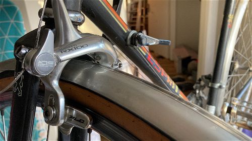 Silver Shimano RX100 brakes on a bike wheel