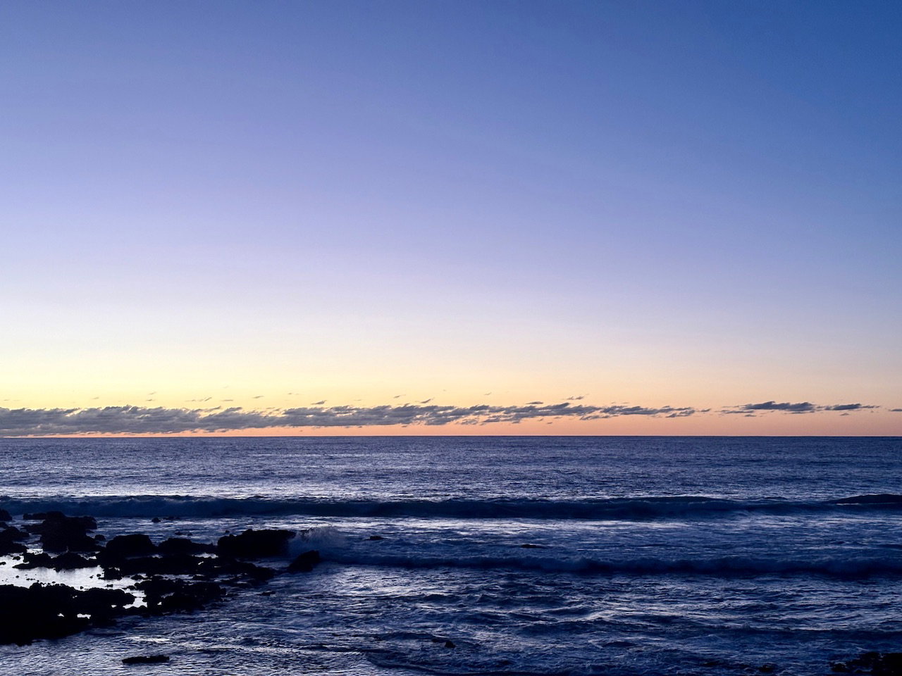 sunset over water on a beach