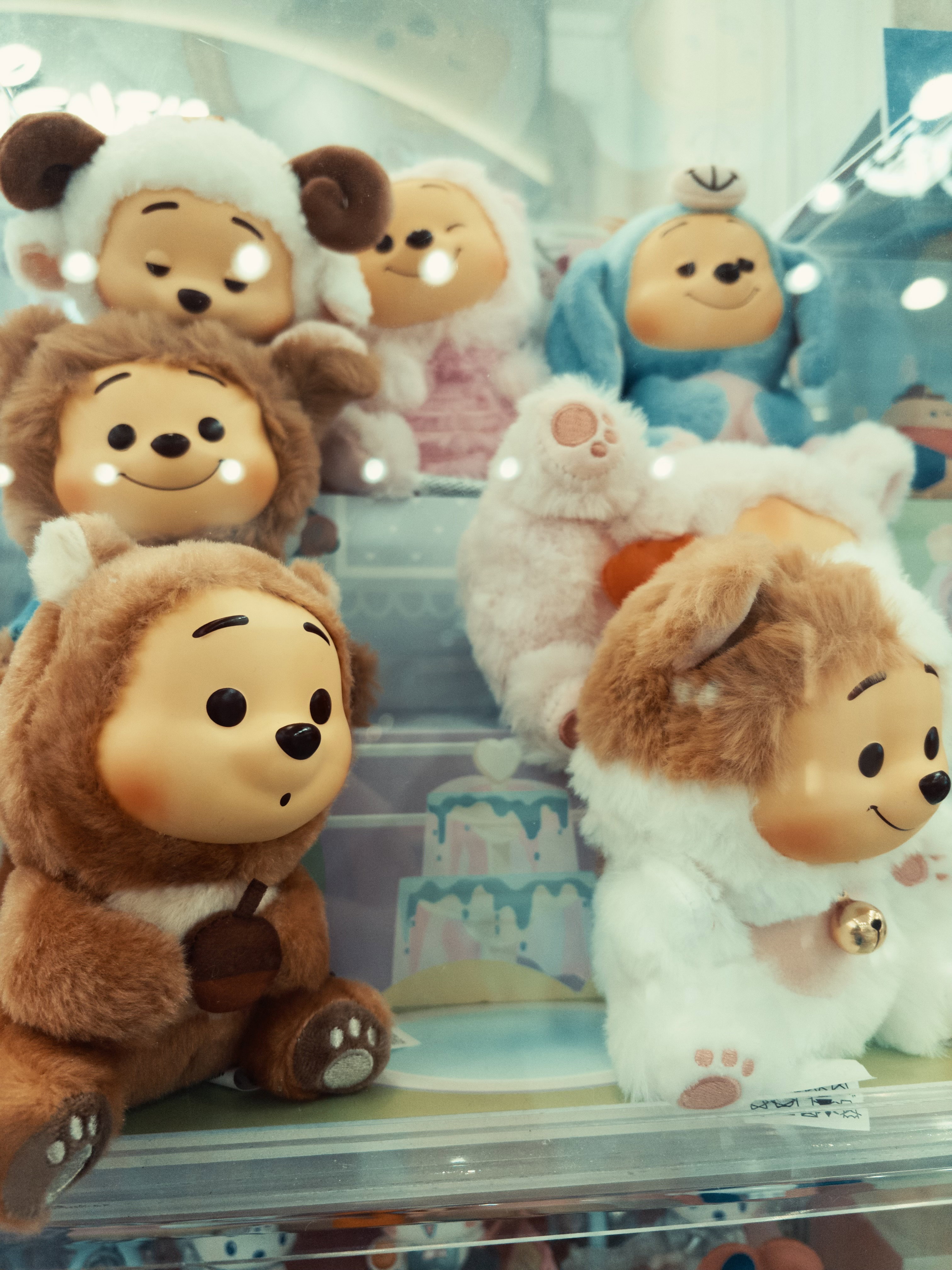 Blind box dolls featuring Winnie the Pooh in various furry costumes.