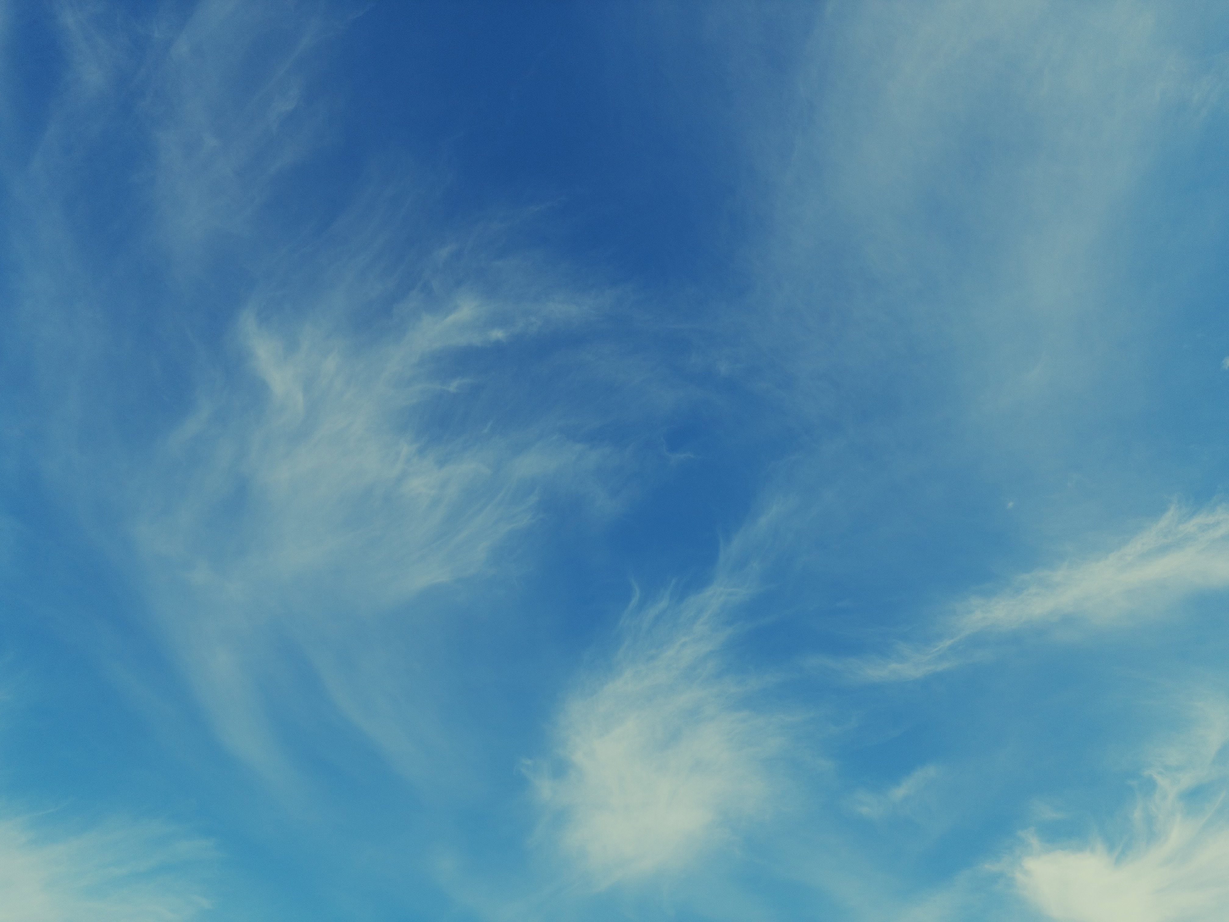 Wispy white clouds against a blue sky.