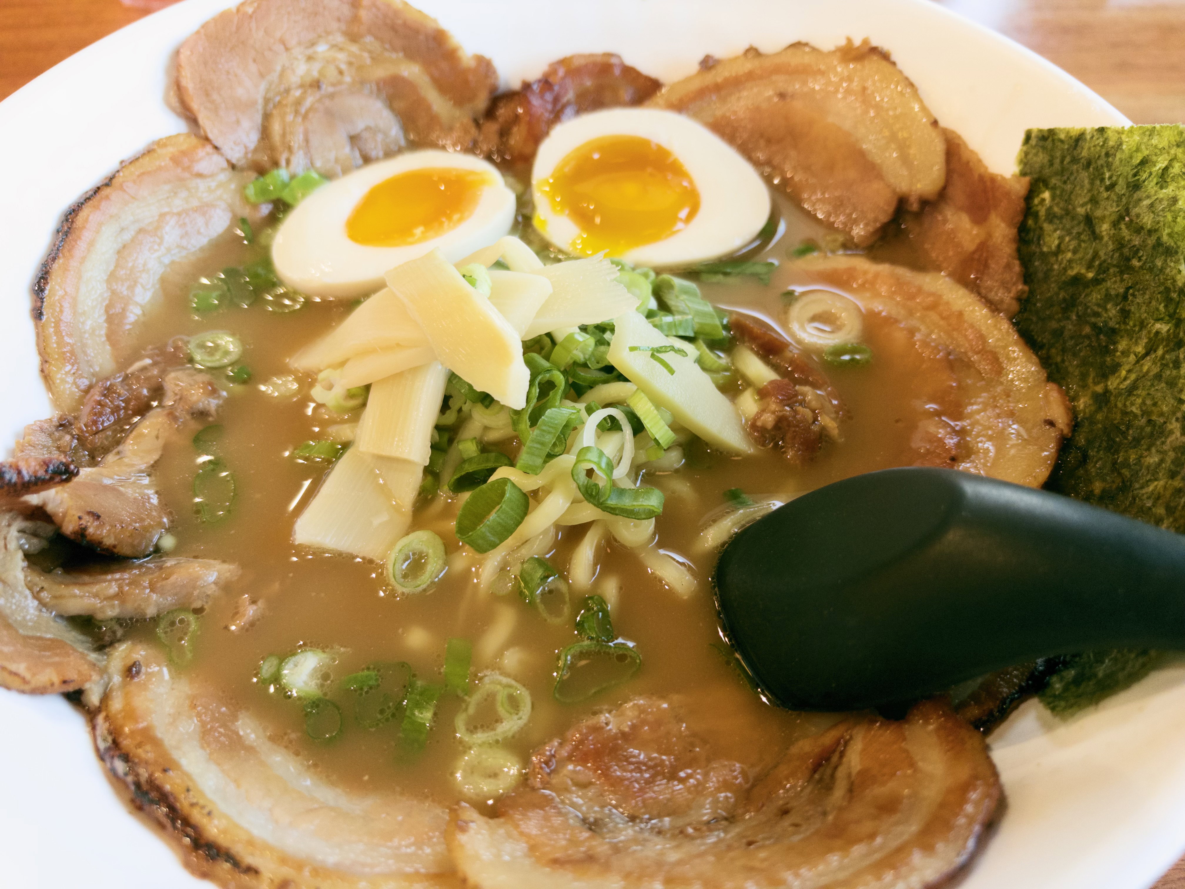 A bowl of ramen with a halved soft-boiled egg.