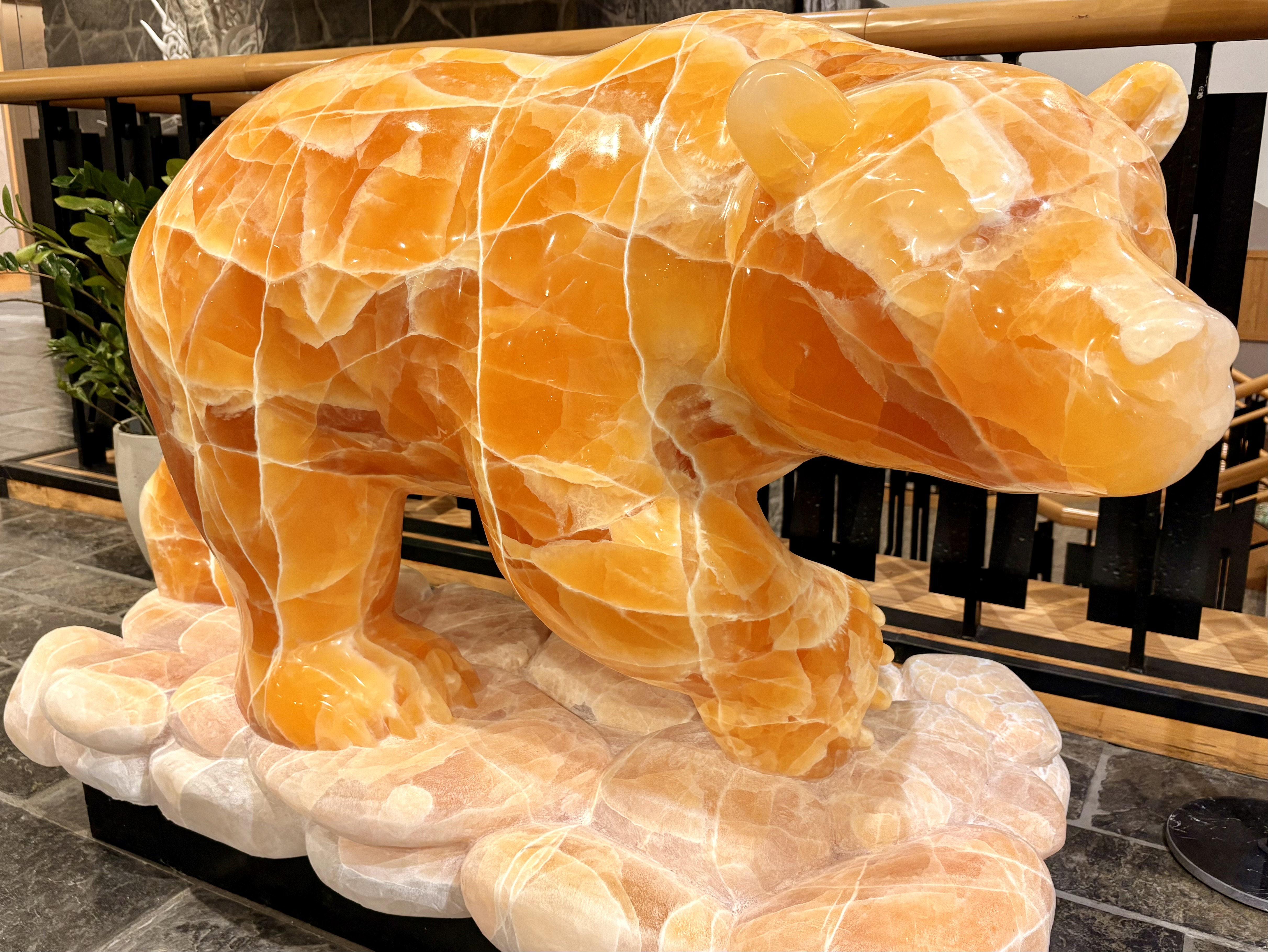 A large bear sculpture carved from Honeycomb Calcite.