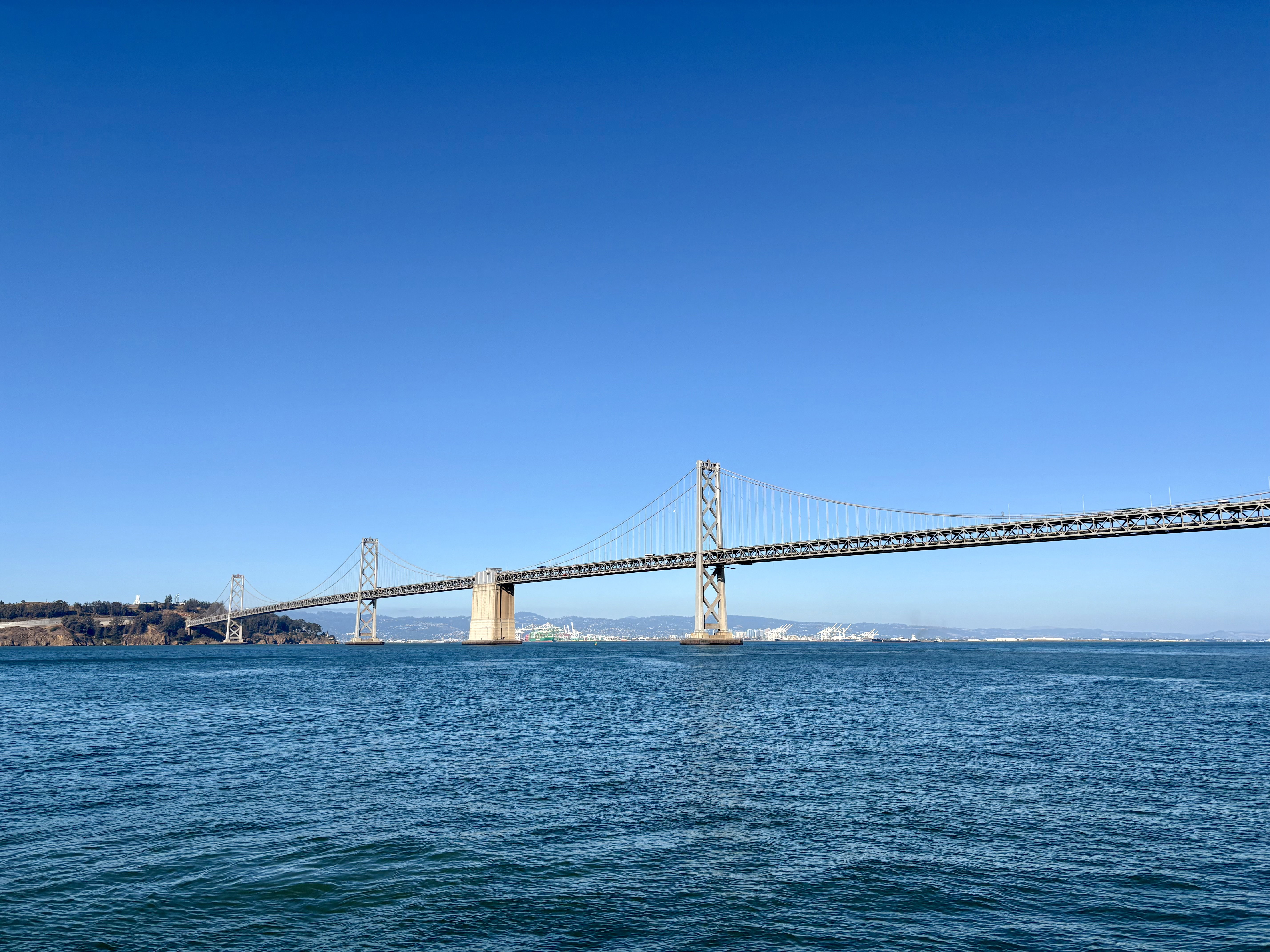A long bridge stretches across a bay.