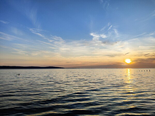 The sun sets over a swiftly rising tide.