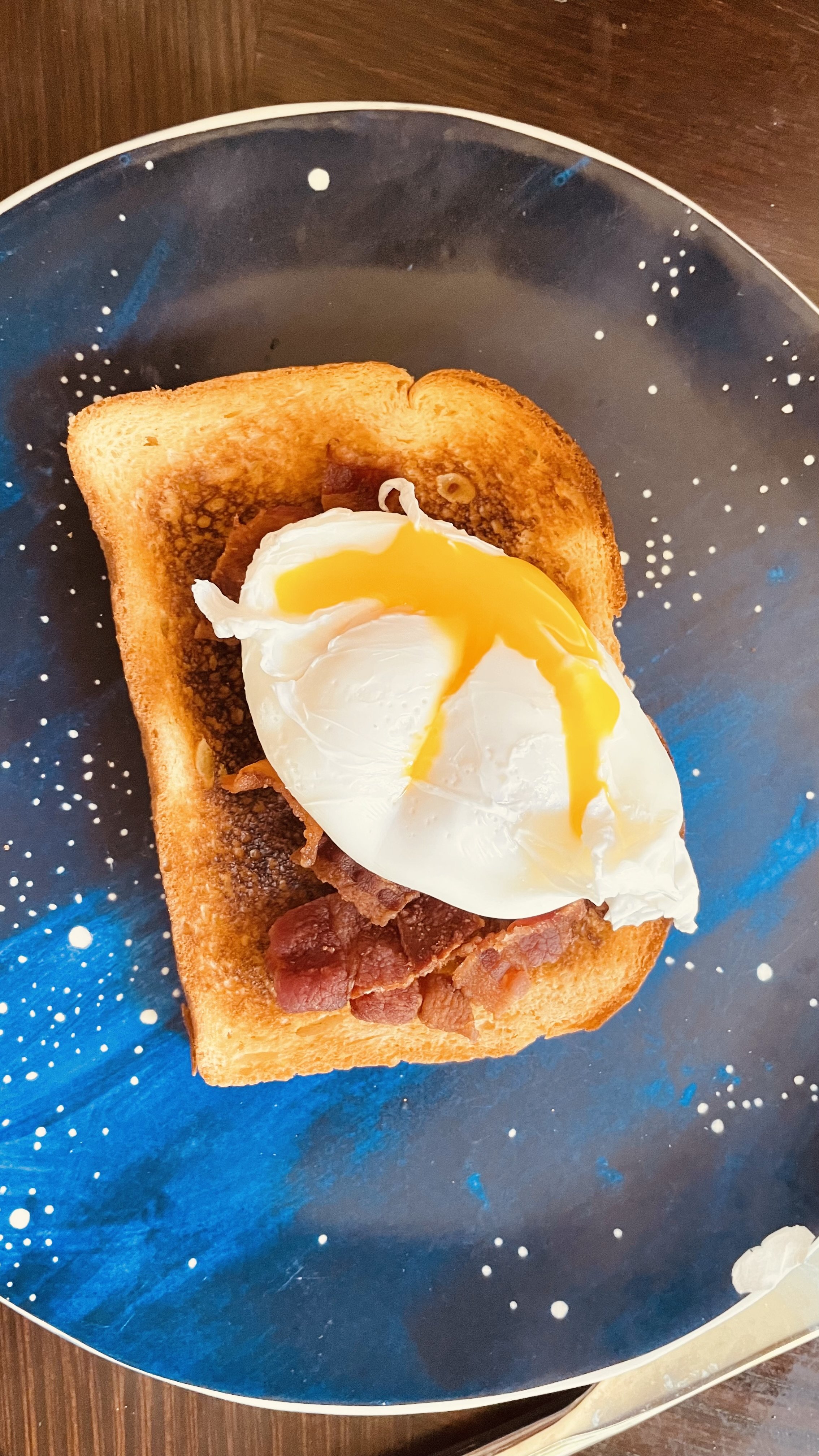Store bought brioche with chopped bacon and a poached egg on top.