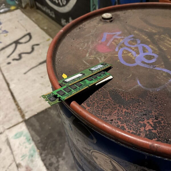Spotted in Graffiti Alley: a lonely pair of RAM sticks perched on a rusty barrel, as if waiting to upgrade the memory of the street itself. Silicon meets spray paint.