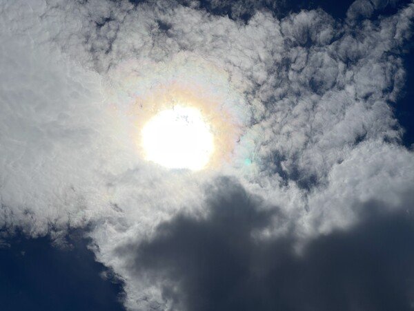 close up of sun with pretty rainbow kinda around the thing clouds too wow i'm so good at this