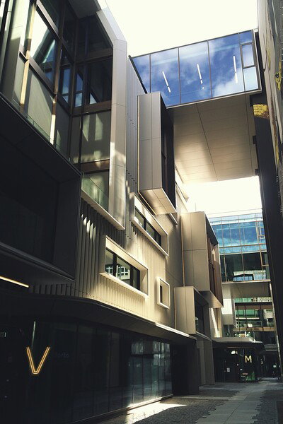Modern architectural scene with sleek buildings, glass windows, and metallic facades