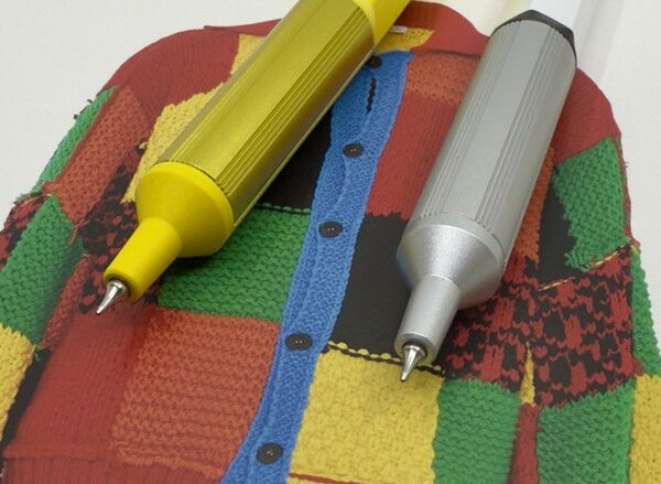 uniball Jetstream Edge 0.28 (left) and 0.38 posing on a postcard of Harry Styles sweater. 