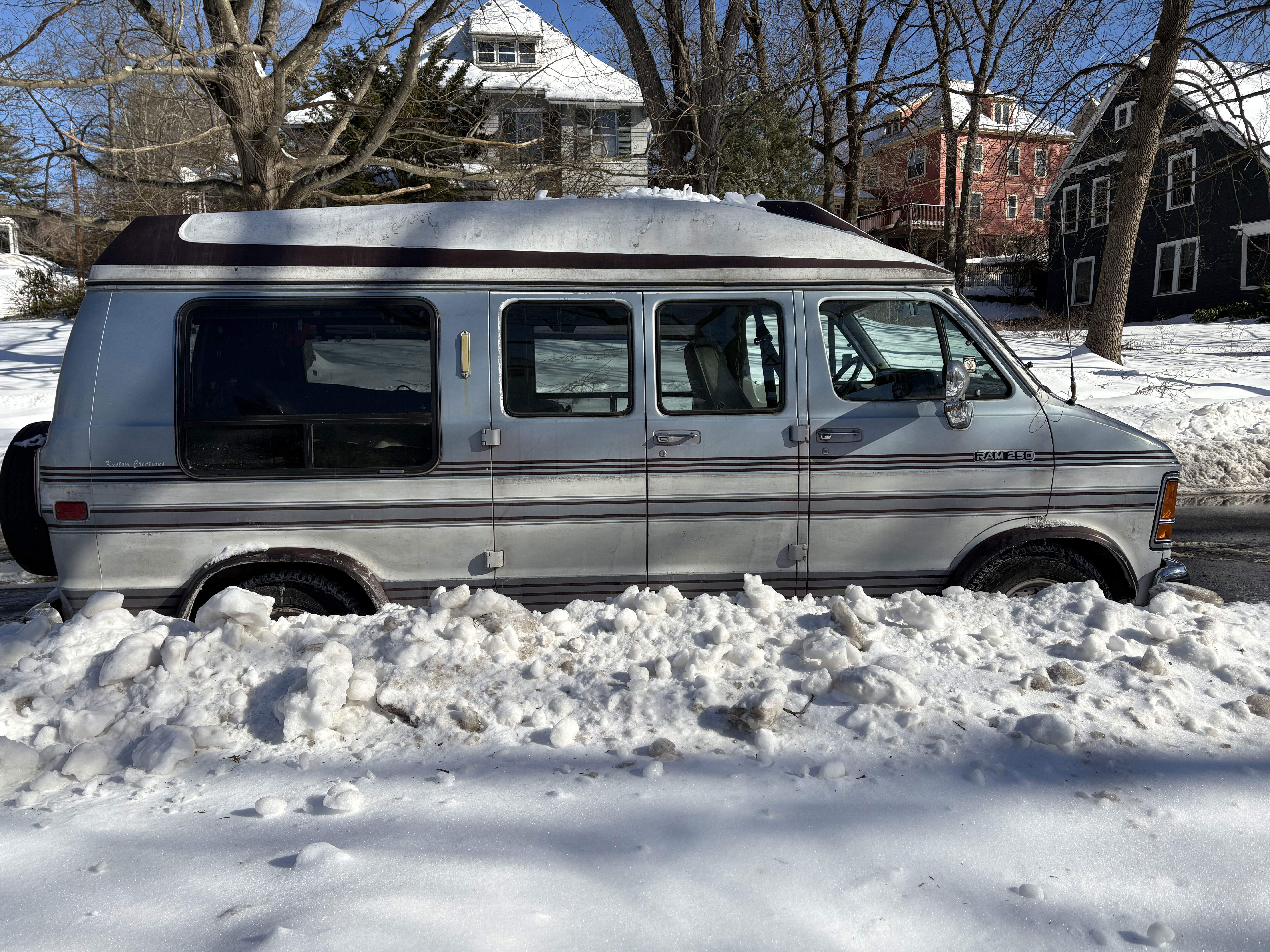 Conversion van parked by snow bank