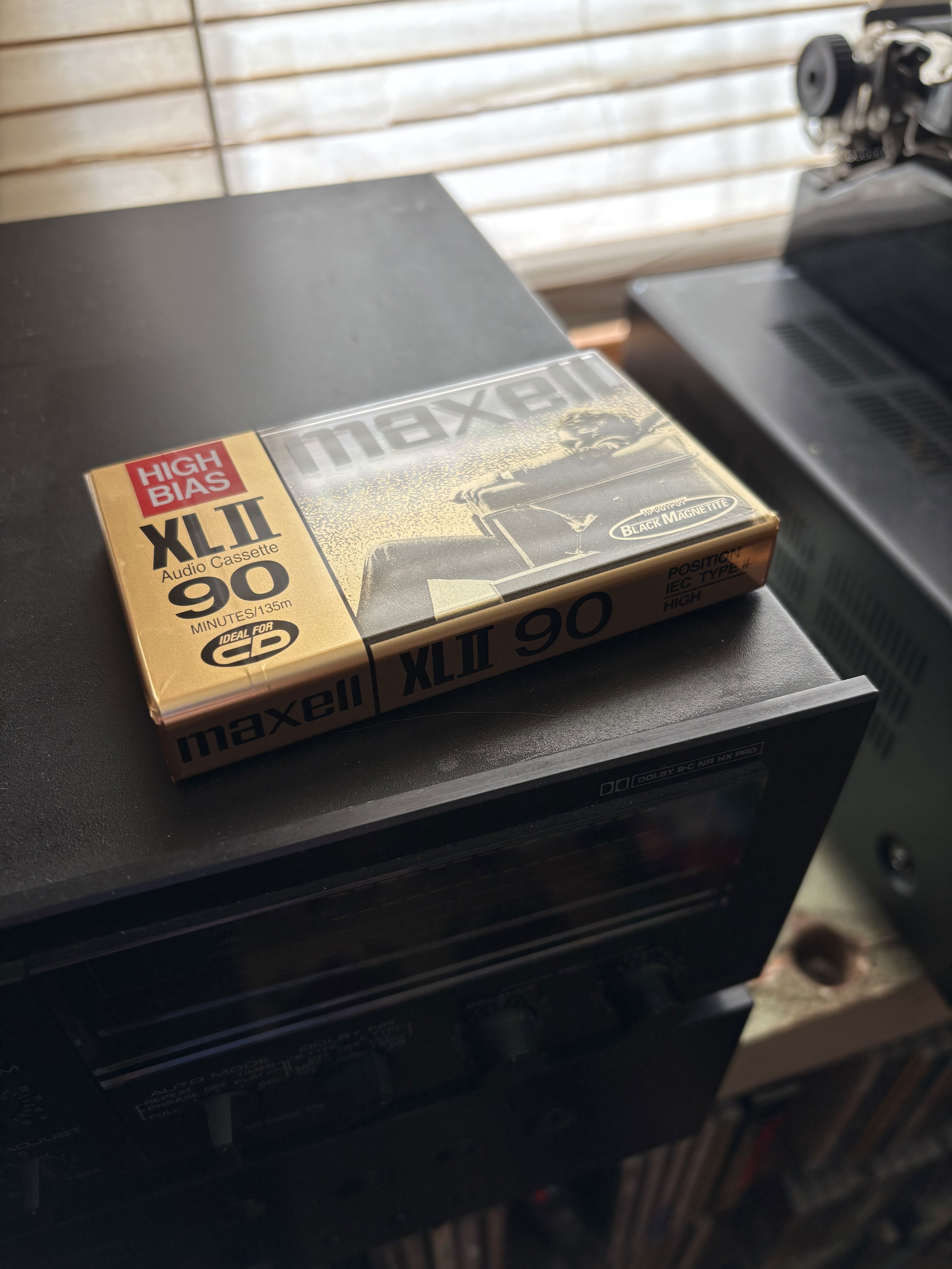 Maxell blank tape on top of a cassette deck