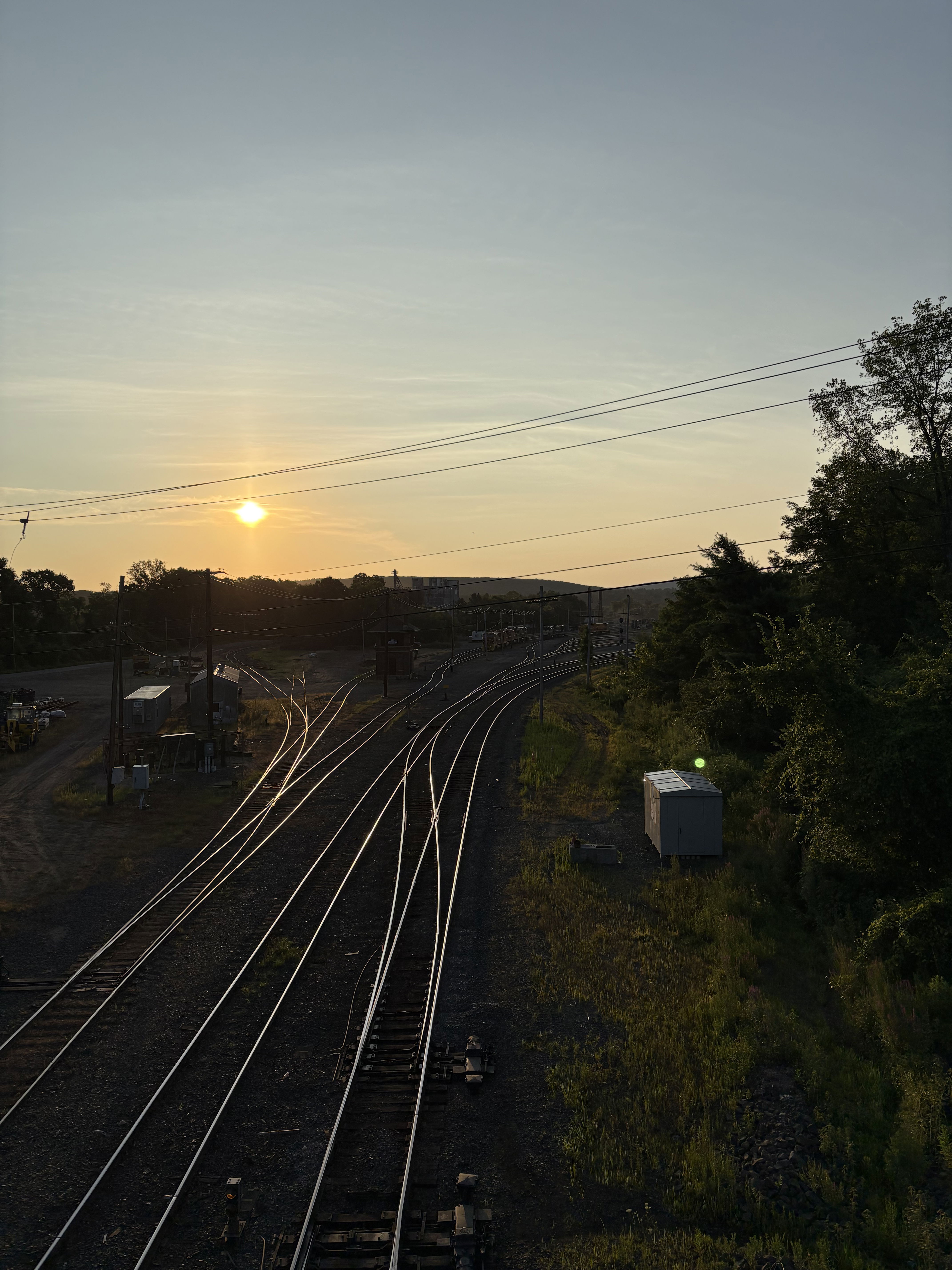Sun and sky over train tracks