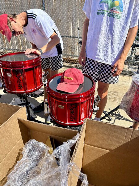 Snare drums for the 2024 edition of the Santa Clara Vanguard, in Ferrari red with special stave shell technology, being unboxed and tuned up. 