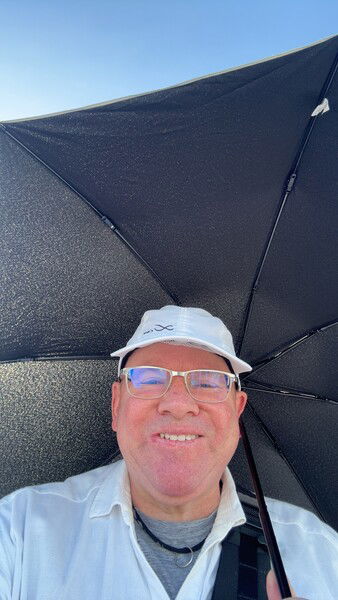 Waiting in line at the Osaka World Expo 2025. Hot! Daughter 1 convinced me to bring a parasol which she even bought. Good decision!
