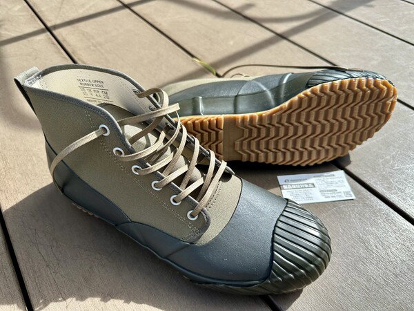 Grey shoes with white lace on a wooden deck in a casual outdoor setting in Totsuka-ku, Yokohama, Japan.