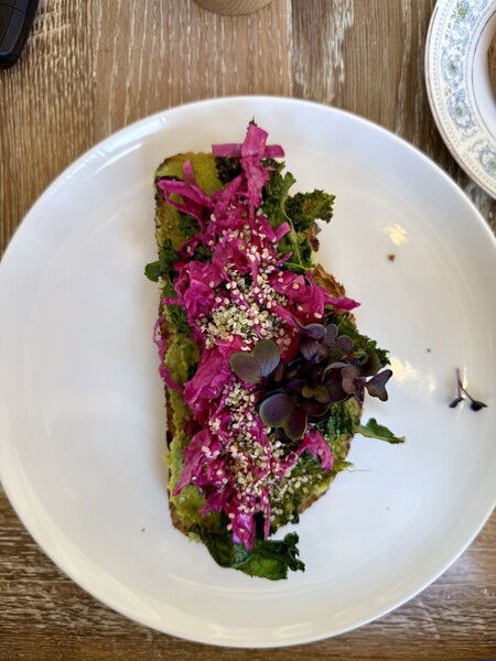 Avocado toast with some pickled vegetables on top. 