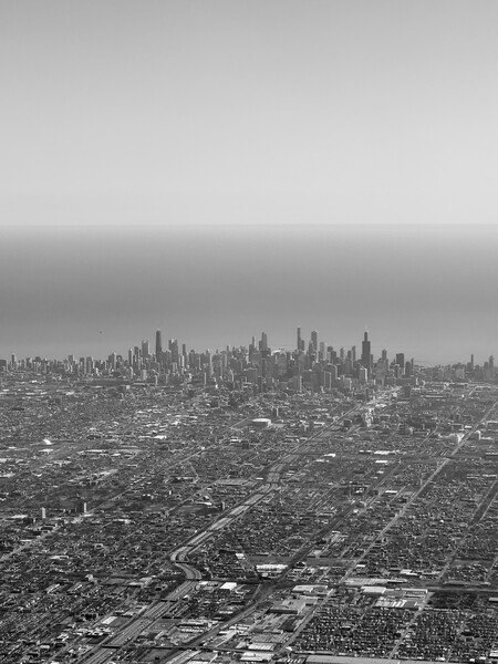 A photo of the Chicago skyline taken from the sky in black & white