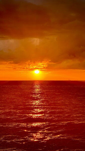 Mobile Bay at sunset, everything shades of orange. 