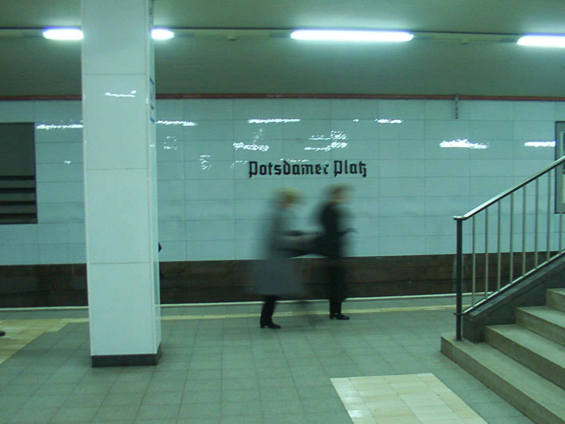 Subway station Berlin Potsdamer Platz. No train, stairs, two blurry people