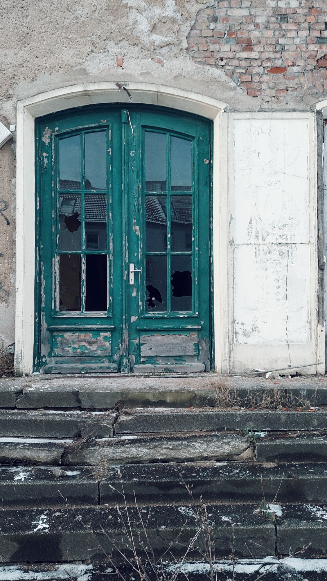 Stairs and door of an abandoned building. 